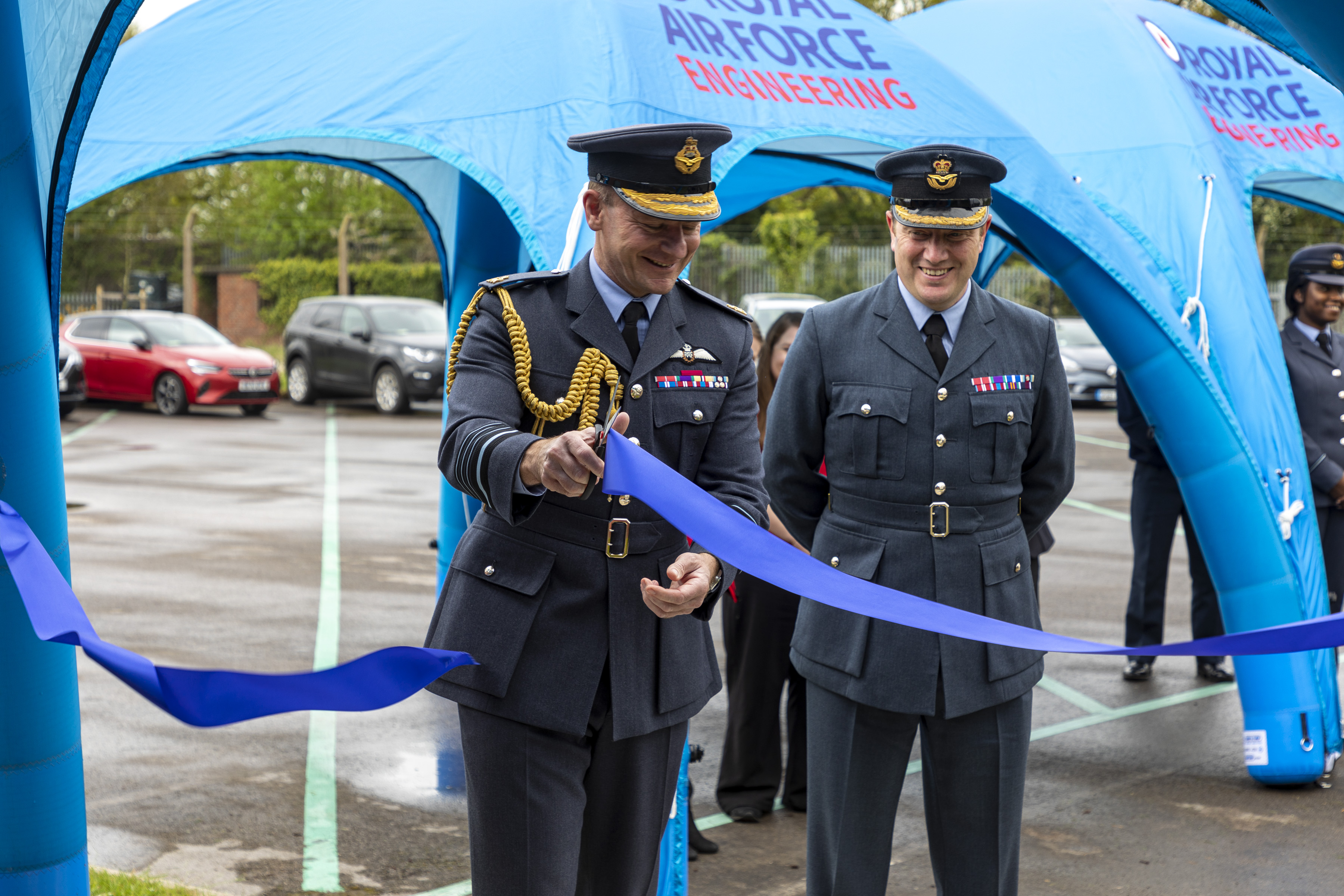 Air Chief Marshal Sir Mike Wigston cuts tape by gazebos.